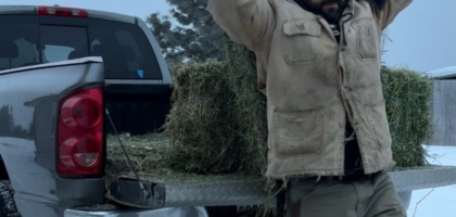 egistered Dietitian Franco Lopez carrying hay on his farm, illustrating the connection between strength, muscle, and metabolic health.
