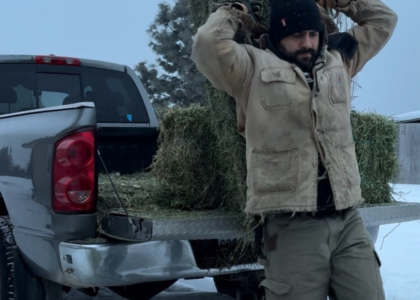 egistered Dietitian Franco Lopez carrying hay on his farm, illustrating the connection between strength, muscle, and metabolic health.
